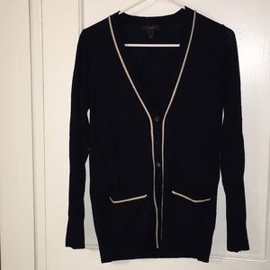 Navy cardigan with cream trim.